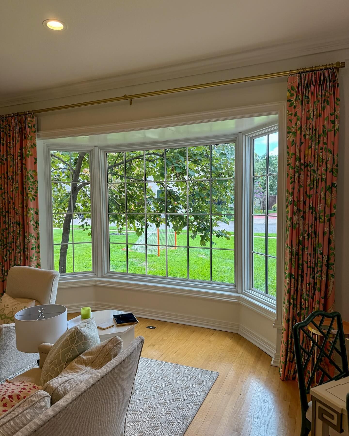 Bay window looking onto a green backyard